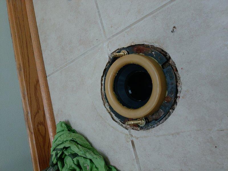 Responded to service call for loose toilet in 24-year-old residential property. Upon inspection, determined toilet required resetting due to compromised wax ring seal and loose floor flange connection. Removed toilet from floor flange, exposing brass closet bolts and existing wax ring. Cleaned flange surface and inspected flange integrity to ensure proper mounting capability. Installed new wax ring seal and repositioned toilet onto flange, ensuring proper alignment with closet bolts. Secured toilet to floor using existing brass bolts, tightening to manufacturer specifications to eliminate movement while avoiding over-compression that could crack porcelain base. Verified toilet stability and tested flush operation to confirm proper seating and seal integrity. Left work area clean with toilet fully functional and securely mounted to floor.