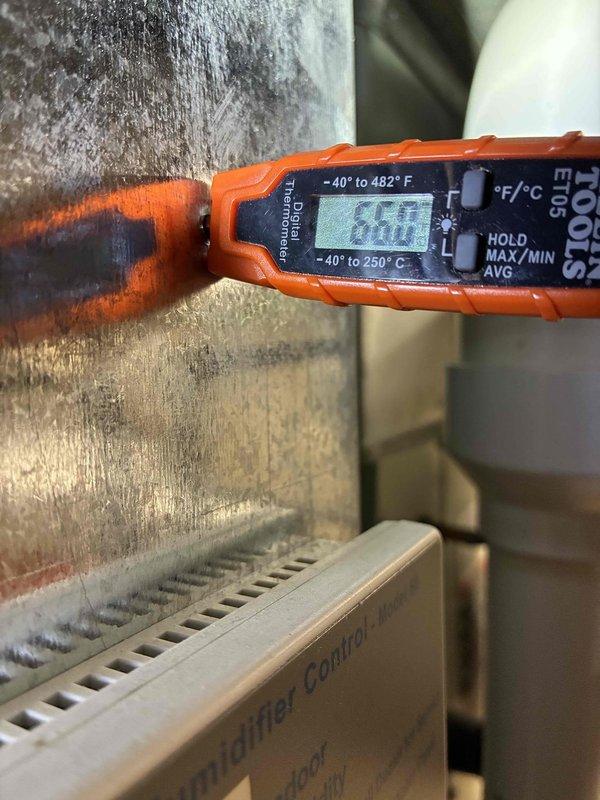 Completed recurring MVP cooling maintenance visit. Performed system diagnostics including temperature measurements of supply air and ductwork, recording 65°F at measurement point. Inspected outdoor condensing unit with access panel removed to evaluate electrical components, capacitor condition, and wiring connections. All electrical connections secure with no visible damage to capacitor or wiring harnesses. System operating within normal parameters with no immediate service needs identified.