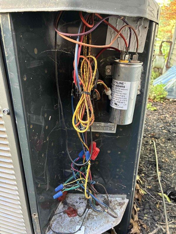 Completed recurring MVP cooling maintenance visit. Performed system diagnostics including temperature measurements of supply air and ductwork, recording 65°F at measurement point. Inspected outdoor condensing unit with access panel removed to evaluate electrical components, capacitor condition, and wiring connections. All electrical connections secure with no visible damage to capacitor or wiring harnesses. System operating within normal parameters with no immediate service needs identified.