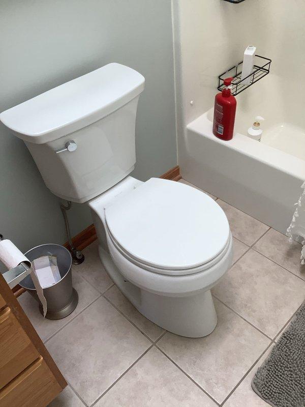 Responded to service call for loose toilet in 24-year-old residential property. Upon inspection, determined toilet required resetting due to compromised wax ring seal and loose floor flange connection. Removed toilet from floor flange, exposing brass closet bolts and existing wax ring. Cleaned flange surface and inspected flange integrity to ensure proper mounting capability. Installed new wax ring seal and repositioned toilet onto flange, ensuring proper alignment with closet bolts. Secured toilet to floor using existing brass bolts, tightening to manufacturer specifications to eliminate movement while avoiding over-compression that could crack porcelain base. Verified toilet stability and tested flush operation to confirm proper seating and seal integrity. Left work area clean with toilet fully functional and securely mounted to floor.