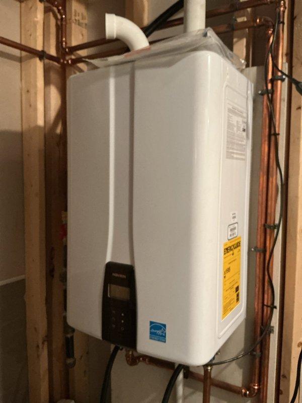 Performed routine maintenance flush on a 3-year-old Navien tankless water heater to remove mineral buildup and maintain optimal performance. Connected descaling pump with flushing solution to the unit's service valves, circulated cleaning solution through the heat exchanger for the manufacturer-recommended duration, and thoroughly rinsed the system. Unit tested successfully after service with proper flow rates and temperature output restored.