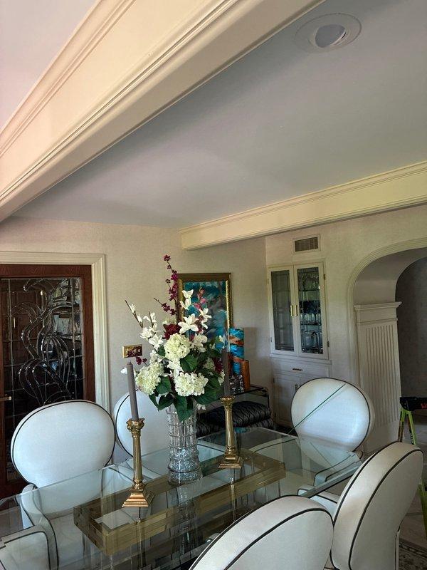 Completed free estimate for chandelier installation in residential dining room with decorative crown molding and recessed ceiling fixture. Assessed existing electrical infrastructure, ceiling support requirements, and fixture mounting location to provide customer with installation options and recommendations.