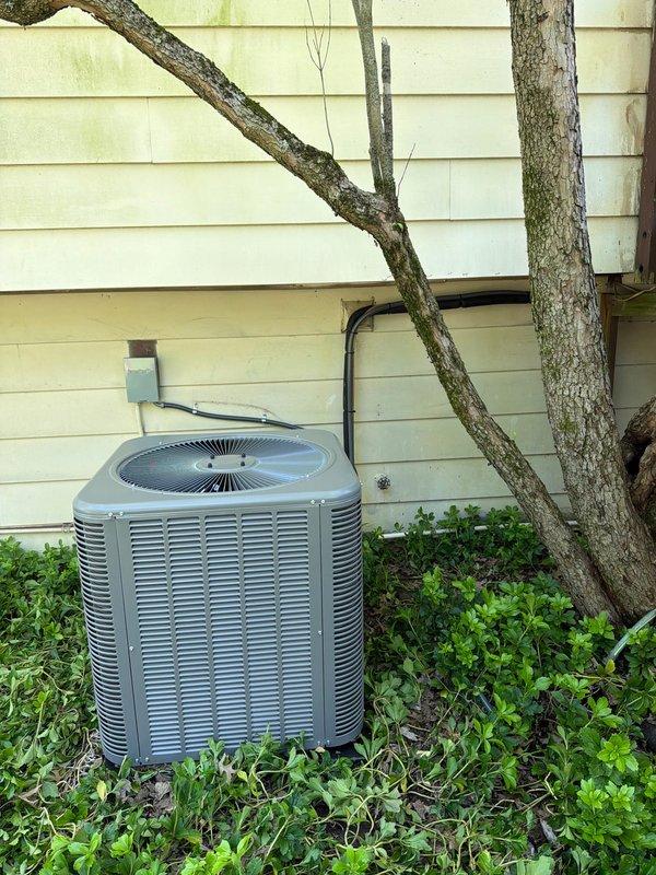 Completed installation of new air conditioning condenser unit and evaporator coil at residential property. Unit was properly positioned on exterior pad with refrigerant lines secured to building structure, electrical connections established with ANR 250 amp fuses, and system tested for proper operation.