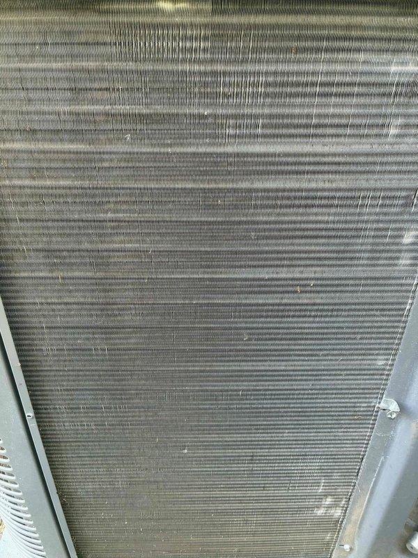 Completed MVP cooling maintenance visit on 7-year-old system. Inspected refrigerant line connections and TXV assembly, confirming proper threading and mechanical integrity. Documented significant dirt and debris accumulation on evaporator coil fins with visible vertical staining patterns indicating restricted airflow. Coil shows moderate contamination requiring attention to maintain optimal heat transfer efficiency and system performance.