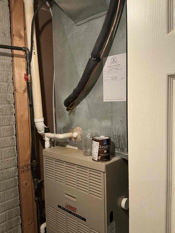 Conducted comprehensive on-site evaluation for complete HVAC system replacement at residential property. Assessed existing 23-year-old Lennox furnace unit currently installed in basement utility area, documenting equipment condition, installation configuration, and surrounding infrastructure including PVC condensate drainage lines, ductwork connections, and electrical service. Photographed current system layout to support replacement proposal development for whole-house heating and cooling equipment upgrade.