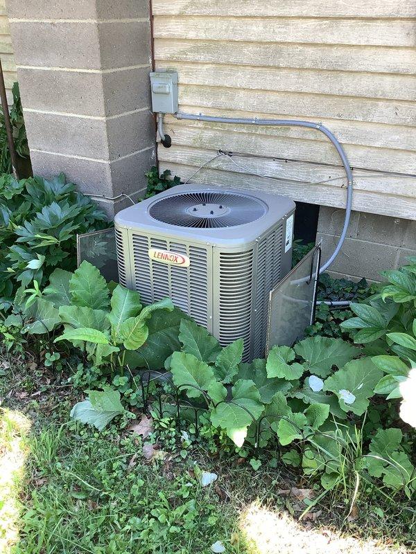 Completed comprehensive MVP cooling maintenance visit on residential Lennox HVAC system. Inspected indoor furnace unit in basement utility area, verifying proper operation of all components, ductwork connections, and associated plumbing including condensate drainage system. Examined outdoor condenser unit, noting vegetation encroachment around equipment that may restrict airflow; documented unit condition and operational status. System photographed for service records showing both indoor and outdoor equipment in functional condition.