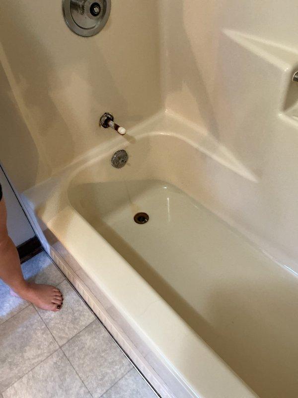 Responded to clogged bathtub drain on upper level. Accessed plumbing system through existing wall cavity to diagnose blockage. Removed wall access panel to inspect vertical copper water lines and drainage system. Cleared obstruction from bathtub drain assembly, including overflow drain mechanism. Verified proper water flow through tub spout and drain. Restored functionality to bathtub fixture and plumbing components.
