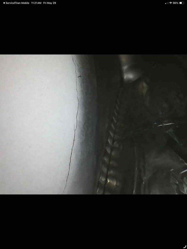 Performed comprehensive air conditioning tune-up on 24-year-old unit. Inspected air handler cabinet, ductwork connections, and internal components; noted accumulated debris and minor discoloration in base pan consistent with unit age. All accessible components evaluated, system operational upon completion.