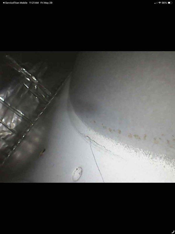 Performed comprehensive air conditioning tune-up on 24-year-old unit. Inspected air handler cabinet, ductwork connections, and internal components; noted accumulated debris and minor discoloration in base pan consistent with unit age. All accessible components evaluated, system operational upon completion.