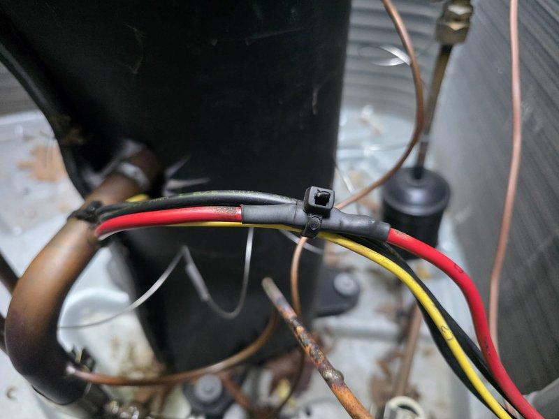 Responded to no cooling call and discovered system was completely empty of refrigerant. Performed leak detection and identified active leak at the suction line service port connection. Documented equipment condition with photos showing oxidized copper tubing, electrical connections, and internal components of outdoor condensing unit. Return visit scheduled to braze and repair the leaking suction line port, pressure test system for additional leaks, and complete refrigerant recharge with truck stock materials.