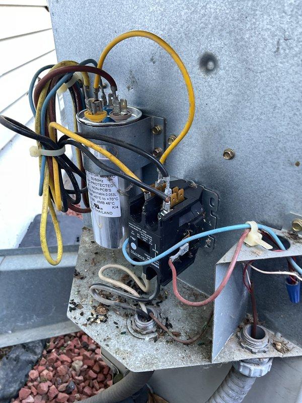 Responded to no-cooling complaint on 26-year-old air conditioning system. Upon inspection, found failed capacitor at outdoor unit with visible corrosion on electrical connections and mounting hardware. Replaced defective capacitor, cleaned electrical contacts, verified proper wire connections at contactor, and tested system operation. Unit restored to normal cooling function with all electrical components operating within specifications.