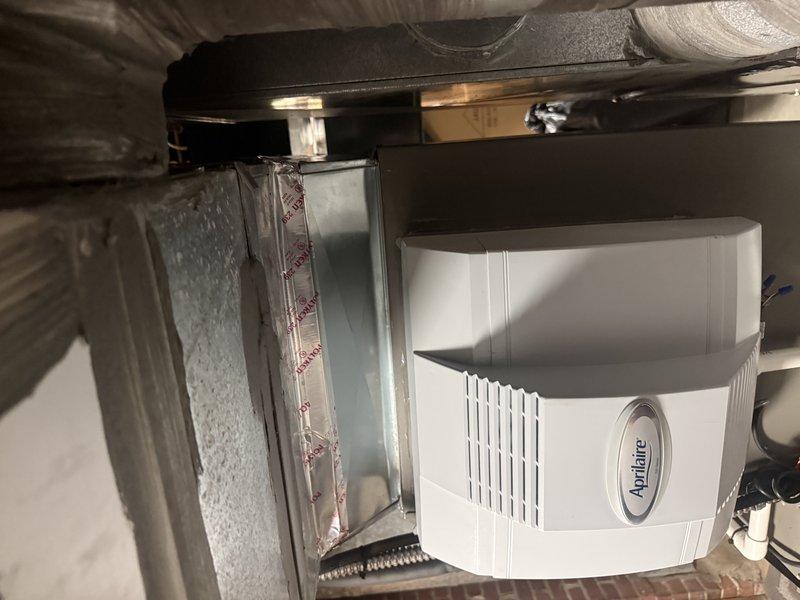Completed warranty inspection corrections on residential HVAC installation to address code compliance issues. Installed tamper-proof service port caps on condenser unit refrigerant lines, established proper 3-inch ground clearance for outdoor condenser unit previously set flush with ground, and ensured adequate clearance space in front of electrical disconnect switch per code requirements. System photographed and held for final manager approval before warranty closure.