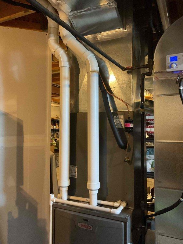 Completed MVP recurring cooling maintenance visit on residential Lennox HVAC system. Performed comprehensive inspection of furnace unit, verified proper operation of ventilation system including PVC intake and exhaust piping, checked ductwork connections and airflow throughout black flexible and metal duct runs, and confirmed all electrical components and controls functioning within normal parameters. System operating efficiently with no issues identified.