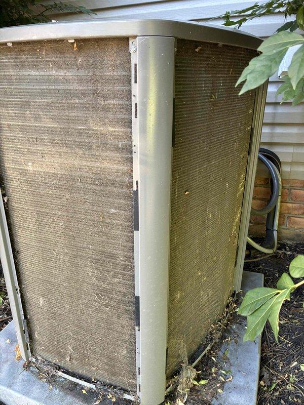 # HVAC Maintenance Service Completed

Performed comprehensive preventive maintenance on a 2-year-old residential cooling system. Upon arrival, conducted thorough inspection of outdoor condenser unit, which exhibited heavy accumulation of dirt, dust, pollen, and organic debris on exterior surfaces and condenser coils. The finned coil surfaces displayed significant brownish-green contamination requiring attention.

Removed access panel to inspect electrical components and internal systems. Verified all electrical connections including capacitor, contactor relay, and associated wiring harnesses. Checked capacitor mounting and secure connections of yellow, red, purple, and black wiring leads. Inspected contactor operation and connection integrity.

Cleaned condenser coil fins to remove accumulated environmental debris and restore proper airflow and heat transfer efficiency. Addressed dirt and debris buildup within equipment compartment. Cleared plant matter and leaves from unit base and su