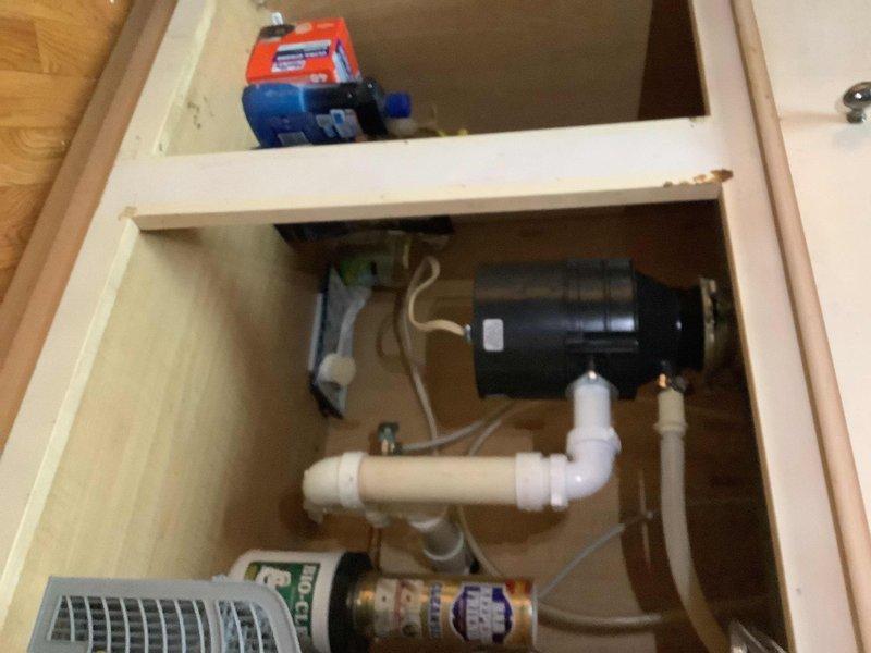 Responded to service call for leaking kitchen sink sprayer and malfunctioning garbage disposal. Inspected under-sink plumbing system and disposal unit, identifying issues with spray hose connection and disposal operation. Performed necessary repairs to eliminate leak at sprayer assembly and restored proper function to garbage disposal unit, including verification of electrical connections and drain line integrity.