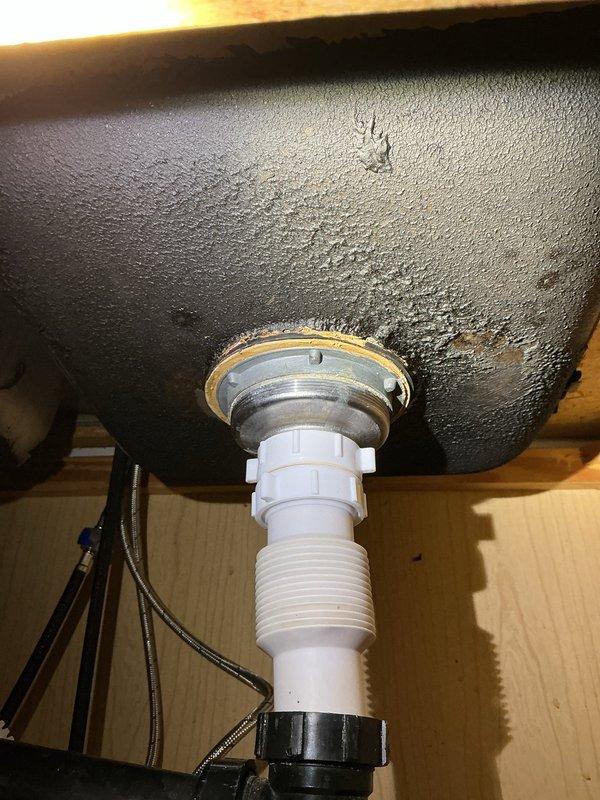 Responded to service call for garbage disposal malfunction and drainage backup issue where kitchen waste water containing food debris was backing up into the bathroom tub. Upon inspection, identified faulty garbage disposal unit beneath kitchen sink and confirmed drainage system obstruction causing cross-contamination between fixtures. Assessed under-sink plumbing configuration including PVC trap assembly and disposal mounting. Repaired garbage disposal unit, addressing mechanical failure and ensuring proper electrical connection and mounting integrity. Cleared blockage in drain line that was causing wastewater to travel from kitchen drain into bathroom plumbing. Verified proper drainage flow from kitchen sink through disposal and confirmed elimination of backup into tub. Tested disposal operation for proper grinding function and verified all connections for leaks. System restored to full functionality with proper drainage throughout affected plumbing fixtures.
