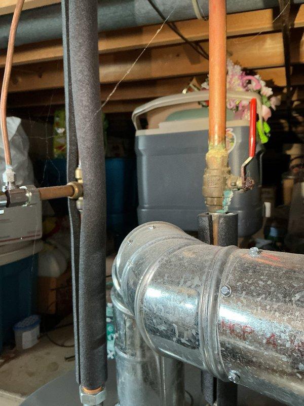 Responded to service call for water heater leaking from bottom. Upon inspection, found existing tanked water heater showing significant corrosion and deterioration on tank surface with visible rust patches and wear throughout the unit. Leak originated from bottom of tank, indicating tank failure. Documented condition of water heater and surrounding plumbing components including pressure tank, water softener, and associated piping systems. Provided assessment and quote for water heater replacement, as unit is beyond economical repair due to extent of tank corrosion and active leak from base.