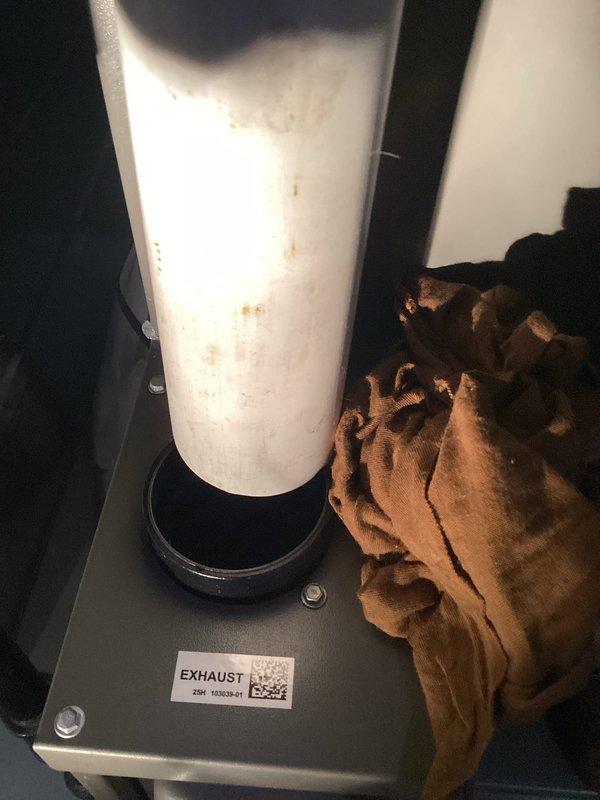 Responded to report of condensation water accumulation around exhaust pipe on newly installed furnace (less than two weeks in service). Upon arrival, inspected furnace installation and exhaust venting system. Observed water staining and moisture present on white PVC exhaust pipe extending from top of unit. Verified exhaust pipe penetration through roof deck and confirmed proper pipe slope for condensate drainage. Inspected exhaust termination point and intake venting configuration. Checked condensate drain system, trap assembly, and drain line routing for proper installation and function. Examined furnace combustion system and heat exchanger operation to rule out internal condensation issues. Documented conditions with photographs showing exhaust pipe staining and overall installation layout. System operating within normal parameters with no safety concerns identified at time of inspection.