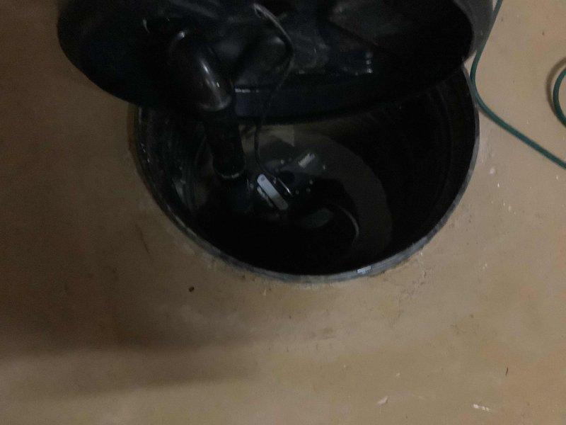 Responded to service call for non-operational sump pump system in residential basement. Upon arrival, found sump pump failed to activate, resulting in water intrusion and significant moisture damage to basement walls as evidenced by extensive staining and discoloration on painted concrete block surfaces. Inspected sump pit and pump assembly, identifying pump failure as primary cause of malfunction. Removed failed pump unit from pit and installed replacement sump pump with appropriate float switch mechanism. Verified proper electrical connections and tested pump operation through multiple cycles to ensure reliable activation at correct water levels. Confirmed discharge piping system remained intact and functional with no blockages or leaks present in horizontal run.