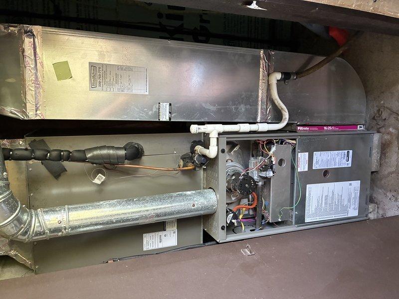 Completed scheduled MVP cooling maintenance visit on 4-year-old residential HVAC system. Upon inspection, discovered severely deteriorated evaporator coil with extensive corrosion and debris accumulation, indicating complete coil failure. Documented system condition with photographs showing yellow air handler unit, integrated cooling components with Filtrete filter installed, and the failed coil component removed from housing. The corroded coil exhibited black oxidation throughout its spiral structure, compromising heat transfer capability and system efficiency. Advised on necessary coil replacement to restore proper cooling function and prevent potential refrigerant leak or complete system failure.