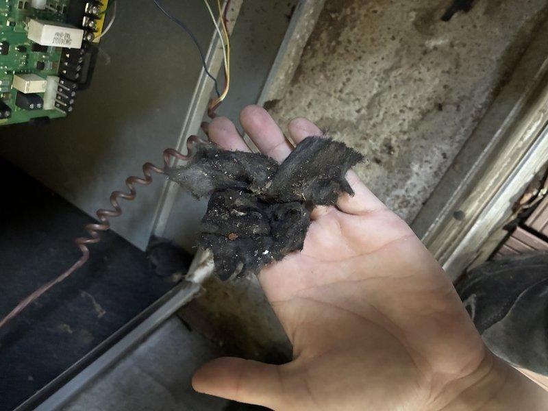 Completed scheduled MVP cooling maintenance visit on 4-year-old residential HVAC system. Upon inspection, discovered severely deteriorated evaporator coil with extensive corrosion and debris accumulation, indicating complete coil failure. Documented system condition with photographs showing yellow air handler unit, integrated cooling components with Filtrete filter installed, and the failed coil component removed from housing. The corroded coil exhibited black oxidation throughout its spiral structure, compromising heat transfer capability and system efficiency. Advised on necessary coil replacement to restore proper cooling function and prevent potential refrigerant leak or complete system failure.