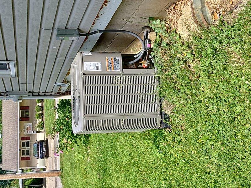 Responded to no-cooling call on recently installed residential AC unit. Upon arrival, found unit attempting to start but failing to run. Removed service panel and performed electrical diagnostics on condensing unit. Measured voltage at capacitor terminals using digital multimeter, which indicated insufficient capacitance at 4.63 microfarads. Identified failed run capacitor as root cause preventing compressor from starting. Replaced defective capacitor with proper OEM replacement, verified correct voltage and amperage readings, and successfully tested unit operation. System now cooling properly with normal startup and run cycle.