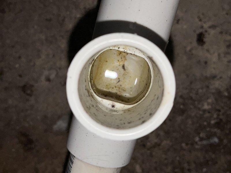 Completed annual maintenance visit on one-year-old air conditioning system for MVP customer. Inspected and documented system components including air filter showing moderate dust and debris accumulation with visible discoloration, and condensate drain line with sediment buildup in PVC piping. All findings photographed and system confirmed operational.