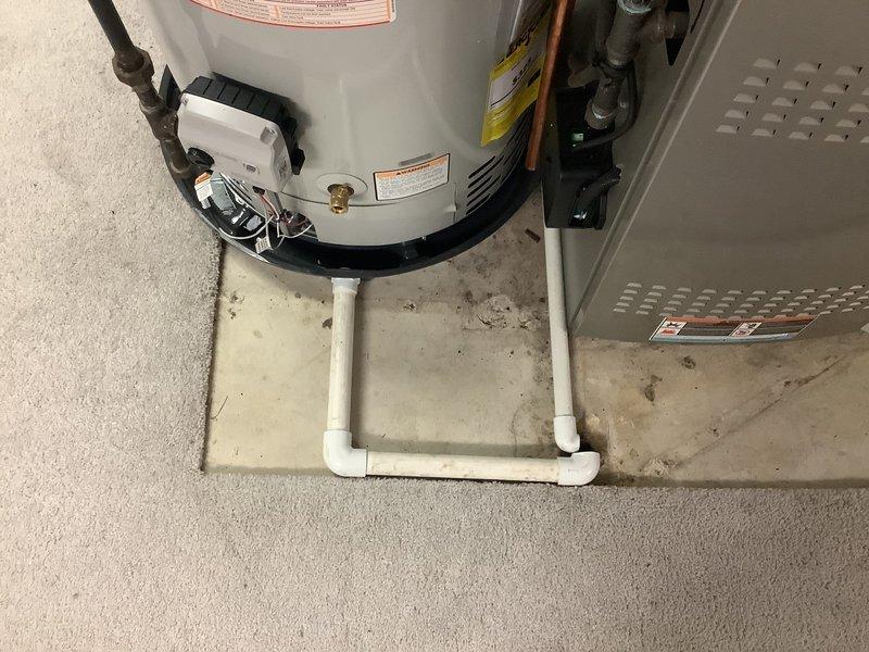 Removed existing water heater and installed new Bradford White 50-gallon residential water heater in utility area. Positioned unit in water safety pan with drain line routed to nearby floor drain for code compliance. Replaced existing shut-off valve with code-approved shut-off valve and installed new thermal expansion tank to protect against pressure buildup. Modified carpet flooring as necessary to accommodate proper installation of water pan. Connected all copper supply lines and verified proper operation of all plumbing connections. Registered new water heater unit with manufacturer upon completion, activating 6-year warranty coverage.