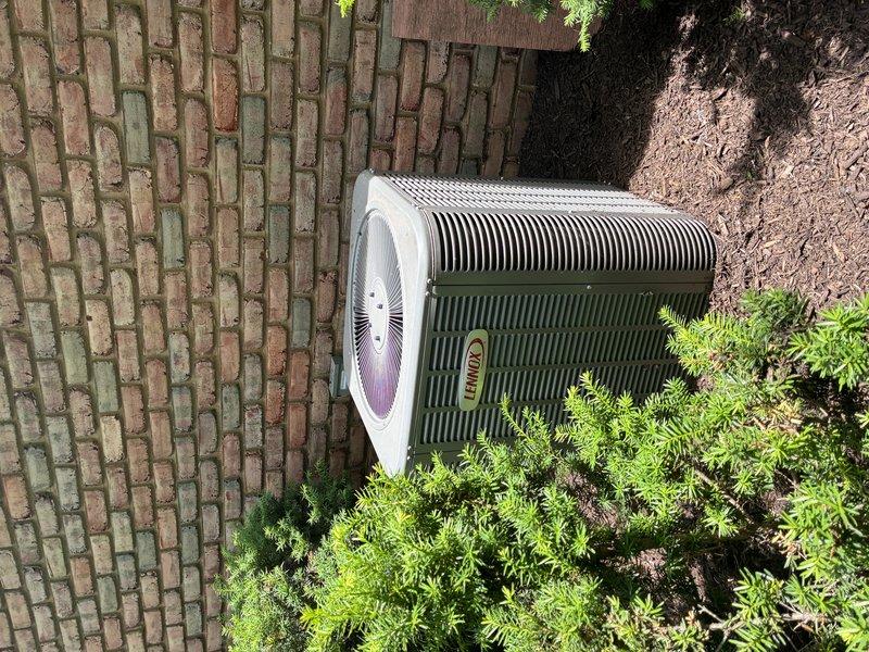 Completed comprehensive AC tune-up on two-year-old cooling system. Inspected and evaluated air filter showing moderate dust accumulation, examined outdoor condenser unit with fan assembly and coil fins in good condition, and verified proper clearance from surrounding landscaping. All components operating within normal parameters with routine maintenance items addressed per manufacturer specifications.