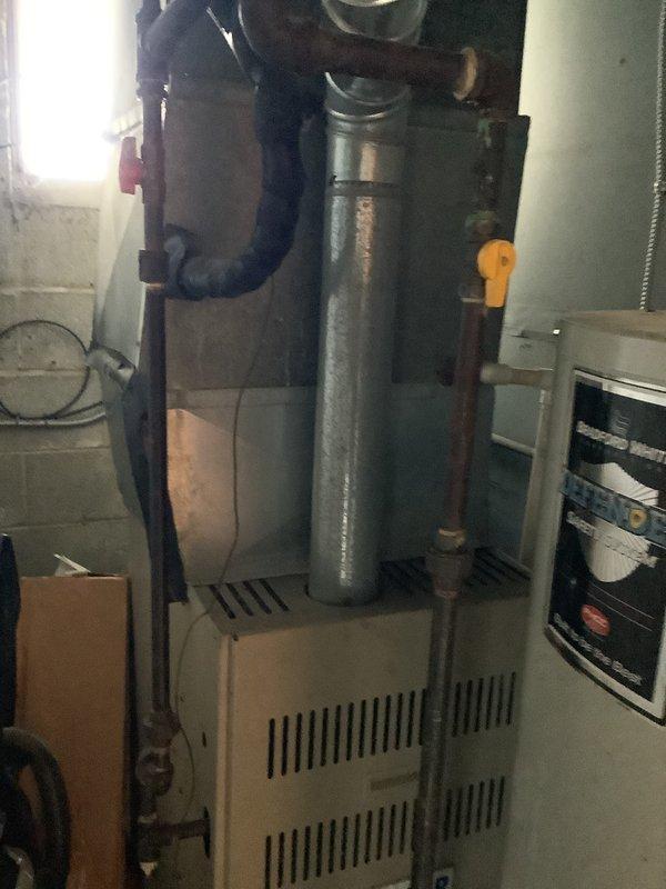 Completed comprehensive HVAC system replacement estimate for aging residential system. Assessed existing outdoor condenser unit showing significant wear and weathering, along with indoor furnace and ventilation components in basement utility area. Documented current equipment condition and specifications to provide complete system replacement proposal.