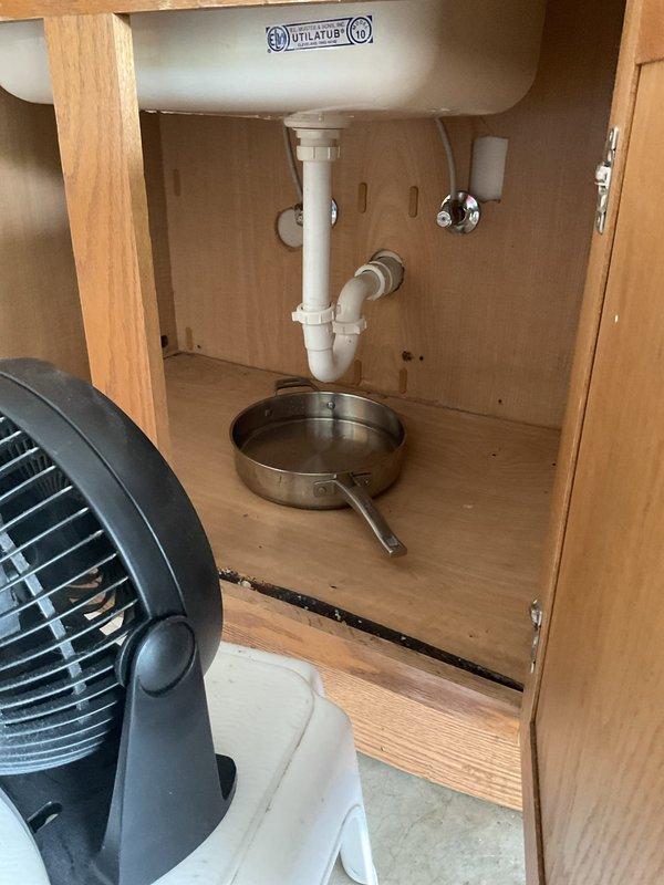 Responded to active leak at utility sink faucet in garage. Upon inspection, identified deteriorated supply hoses as source of leak. Shut off water supply valves and removed failed hoses from faucet connections. Installed new braided stainless steel supply lines with proper compression fittings to both hot and cold water inlets. Restored water supply, tested faucet operation, and verified all connections were secure with no leaks present. Cleaned work area and removed old hoses from premises.