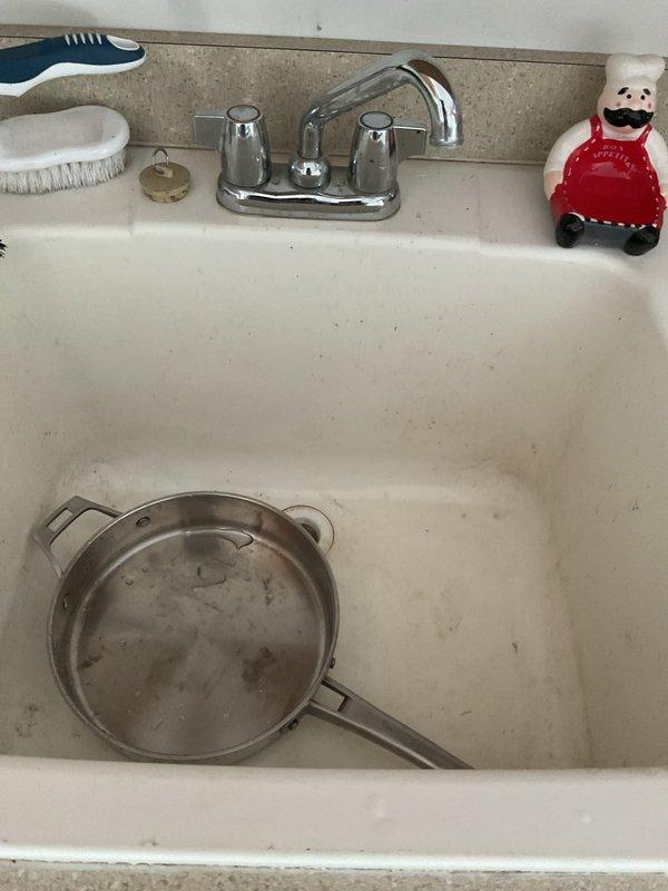 Responded to active leak at utility sink faucet in garage. Upon inspection, identified deteriorated supply hoses as source of leak. Shut off water supply valves and removed failed hoses from faucet connections. Installed new braided stainless steel supply lines with proper compression fittings to both hot and cold water inlets. Restored water supply, tested faucet operation, and verified all connections were secure with no leaks present. Cleaned work area and removed old hoses from premises.