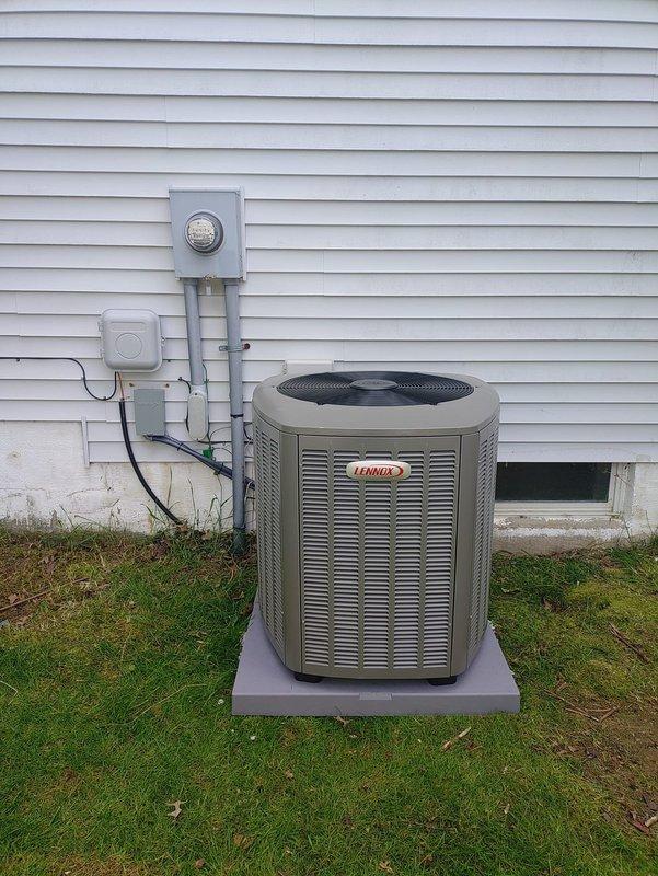Completed full HVAC system installation including new Lennox outdoor condensing unit and furnace with 90% AFUE rating. Mounted condenser unit on concrete pad at exterior of residence with proper clearances from foundation and utility components. Installed new electrical disconnect with Edison ECNR35 time-delay dual-element Class RK1 fuses rated at 200A, 250V AC for equipment protection. Routed electrical conduit from meter base to disconnect and condensing unit per code requirements. Verified proper electrical connections, refrigerant charge, and system operation. All equipment tested and operational upon completion.