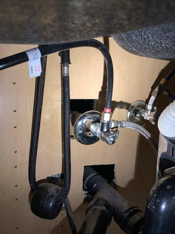 Responded to kitchen faucet leak complaint and performed comprehensive assessment of existing matte black faucet installation. Inspected above-counter components including tall curved spout, dual vertical supply pipes, and side spray attachment for signs of wear or damage. Examined under-sink plumbing connections, including chrome angle stop valves, flexible braided supply lines, and drain assembly. Discussed repair versus replacement options with customer, documented current installation with photographs, and provided recommendations for addressing the leak issue based on fixture condition and customer preferences.