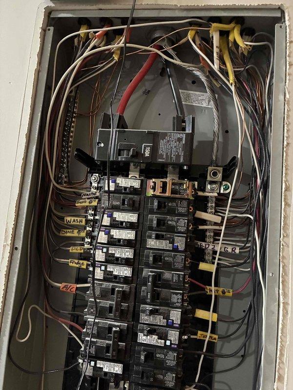 Repurposed existing electrical circuit from decommissioned electric water heater to support new outdoor appliance installation. Converted circuit to 20-amp configuration at main panel and installed two dedicated branch circuits extending from basement junction box to backyard location. Installed drywall access panel in basement ceiling to facilitate wire fishing and future service access. Ran new wiring through basement to exterior wall penetration, terminating at weatherproof outdoor receptacle on back porch for dedicated Traeger smoker connection. All work performed to code with proper circuit protection and GFCI requirements for outdoor application.
