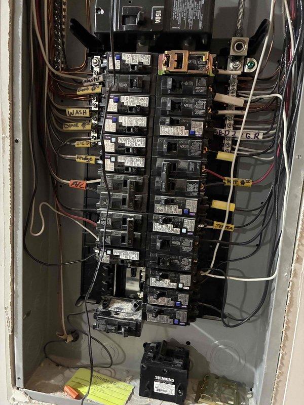 Repurposed existing electrical circuit from decommissioned electric water heater to support new outdoor appliance installation. Converted circuit to 20-amp configuration at main panel and installed two dedicated branch circuits extending from basement junction box to backyard location. Installed drywall access panel in basement ceiling to facilitate wire fishing and future service access. Ran new wiring through basement to exterior wall penetration, terminating at weatherproof outdoor receptacle on back porch for dedicated Traeger smoker connection. All work performed to code with proper circuit protection and GFCI requirements for outdoor application.
