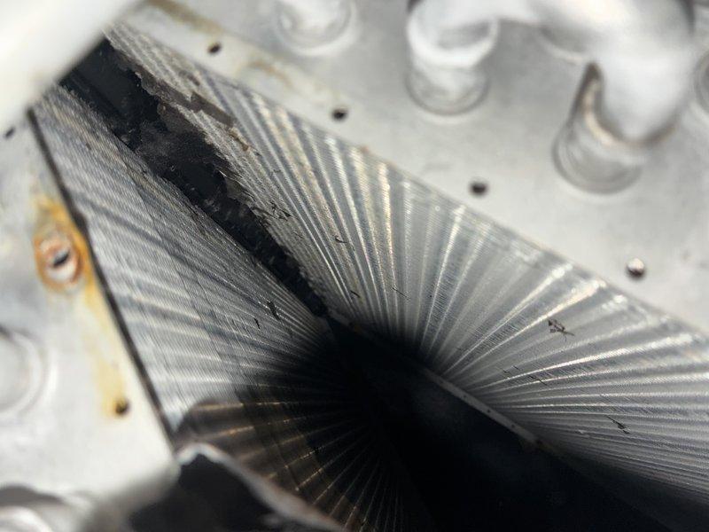 Completed MVP cooling maintenance visit on 16-year-old HVAC system. Inspected blower wheel assembly and evaporator coil, documenting normal dust accumulation on blower blades and dark discoloration with debris buildup on evaporator fins. Unit operational with age-appropriate wear patterns observed throughout components.