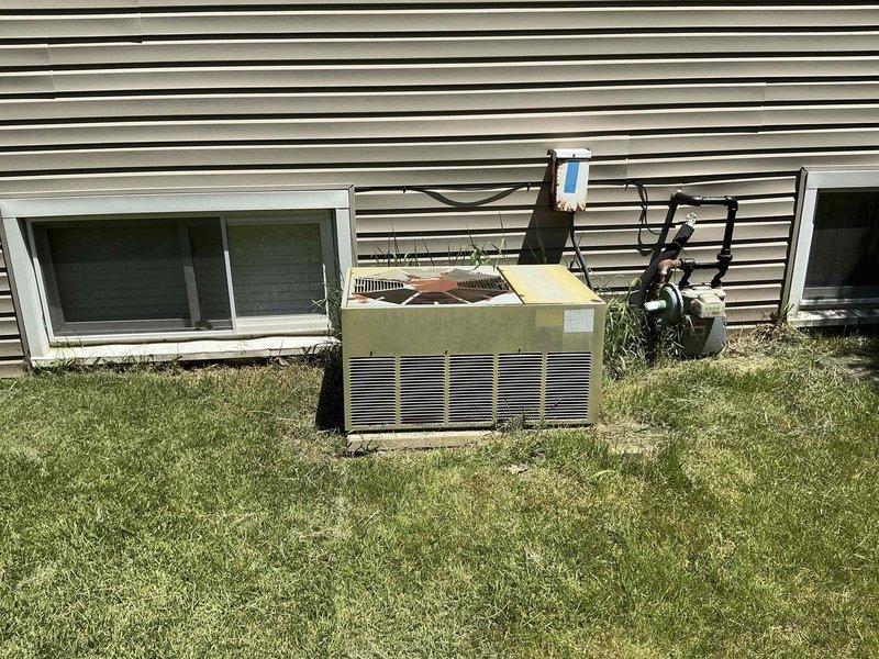 Conducted comprehensive HVAC system evaluation for replacement estimate on 1970s-era residential air conditioning unit and indoor air handler. Assessed exterior condensing unit showing significant age-related deterioration and indoor ductwork components to provide multiple replacement options for complete system upgrade.