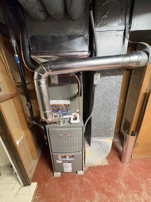 Completed full HVAC system installation including an 80% efficiency furnace and air conditioning unit in basement location. Due to water issues in the basement, elevated the furnace on a platform box to protect equipment from potential flooding. Installation included proper ductwork configuration with metal supply and return plenums, copper refrigerant line set connecting outdoor condensing unit to indoor coil, gas supply line with ball valve shutoff, condensate drainage system, and electrical connections. All components mounted securely to structural framing with appropriate clearances maintained for service access and code compliance.