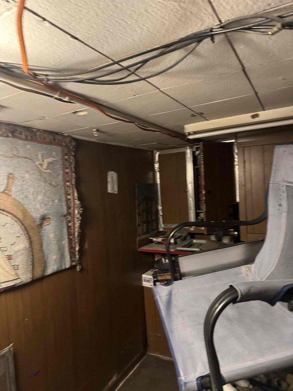 Responded to service call for non-functioning electrical circuit serving garage. Performed diagnostic assessment of electrical system including inspection of interior switch controls, main panel neutral connections, and garage sub-panel. Traced circuit routing through basement utility area to identify potential points of failure. Documented existing wiring configuration and overhead cable routing for further evaluation and repair recommendations.