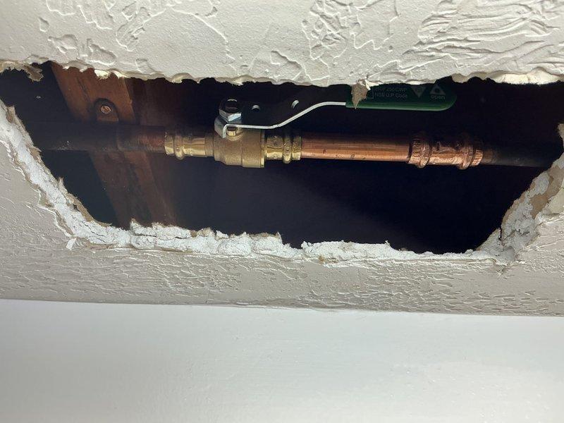 Accessed exterior sillcock supply line through ceiling opening prepared by homeowner. Removed existing gate valve from copper pipe and installed new ball valve using truck stock materials. Completed valve replacement to restore proper shutoff functionality for exterior hose bibb. Spigot replacement was not included in scope of work.