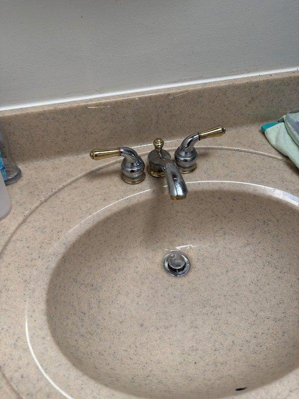 Responded to service call for multiple plumbing issues including a continuously running toilet, leaking bathroom faucet, and improperly sealing bathtub stopper. Upon arrival, wore mask per customer request and conducted diagnostic assessment of all reported concerns. Inspected bathroom sink faucet assembly with chrome spout and dual-handle configuration, identifying source of leak and performing necessary repairs to restore proper function and eliminate water waste. Examined bathtub drain assembly and stopper mechanism, addressing seal failure to ensure proper water retention. Evaluated toilet for continuous running condition and resolved internal component malfunction. Documented existing conditions with photographs showing bathroom fixtures including sink basin with integrated countertop and bathtub drain assembly. All repairs completed successfully, restoring full functionality to plumbing fixtures and eliminating water leakage issues throughout the bathroom.