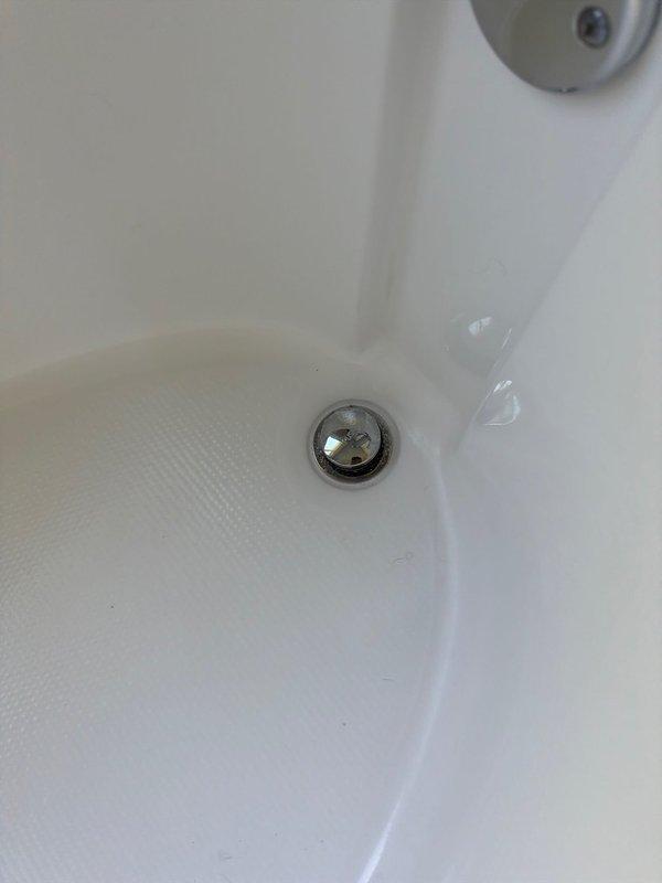 Responded to service call for multiple plumbing issues including a continuously running toilet, leaking bathroom faucet, and improperly sealing bathtub stopper. Upon arrival, wore mask per customer request and conducted diagnostic assessment of all reported concerns. Inspected bathroom sink faucet assembly with chrome spout and dual-handle configuration, identifying source of leak and performing necessary repairs to restore proper function and eliminate water waste. Examined bathtub drain assembly and stopper mechanism, addressing seal failure to ensure proper water retention. Evaluated toilet for continuous running condition and resolved internal component malfunction. Documented existing conditions with photographs showing bathroom fixtures including sink basin with integrated countertop and bathtub drain assembly. All repairs completed successfully, restoring full functionality to plumbing fixtures and eliminating water leakage issues throughout the bathroom.