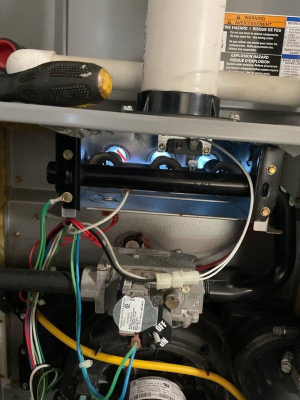 Completed comprehensive MVP maintenance on furnace and air conditioning system. Performed thorough inspection of heating components including burner assembly, ignition chamber, gas valve, blower motor, and all electrical connections. Verified proper flame operation with visible blue flame indicators and tested system controls for safe operation. Measured and recorded temperature differential readings at 12.18°F to confirm adequate heat exchange performance. All components found operating within manufacturer specifications with proper wire management and secure mounting throughout the unit.