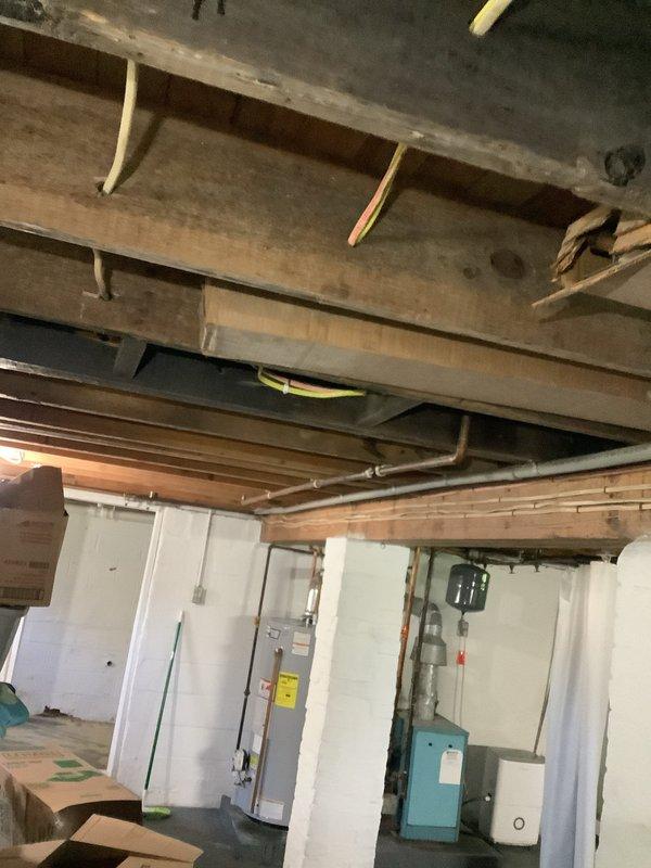 Installed 6/3 AWG aluminum conductor circuit for air conditioning unit, running from main electrical panel through basement ceiling joists to exterior meter location. Secured all conduit and wiring per NEC requirements, utilizing proper supports and fasteners throughout the installation path. Completed exterior meter connections with weatherproof fittings and verified proper grounding at all termination points.