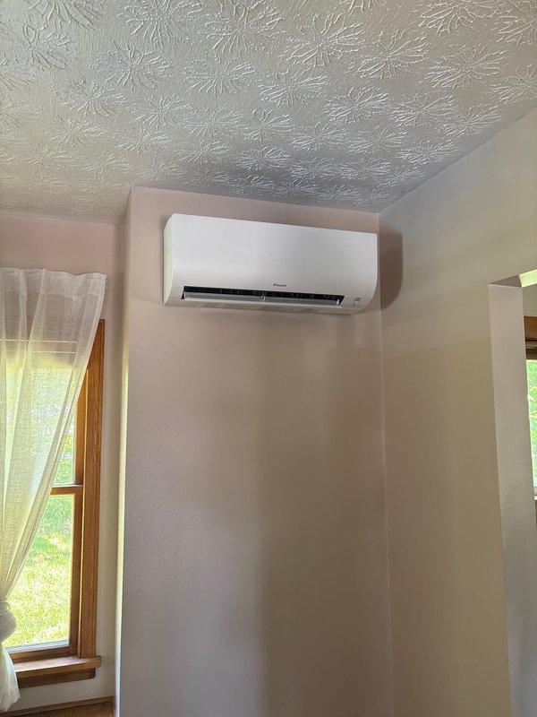 Completed installation of a 2-zone ductless mini-split system. Mounted indoor air handler unit on interior wall with proper clearances and secure mounting hardware. Installed electrical disconnect with FNR 20A fuses and completed all line set connections between outdoor condenser and indoor unit. Verified proper refrigerant lines, drainage, and electrical wiring connections. System tested and operational upon completion.