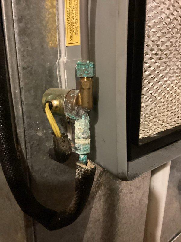 Completed routine MVP cooling maintenance visit on HVAC system. Inspected electrical components, wiring connections, and refrigerant lines within the air handler compartment, confirming all connections were secure and operational. Examined condensate drain valve and associated plumbing, noting mineral deposits and corrosion present on brass fittings consistent with normal system age and water exposure.