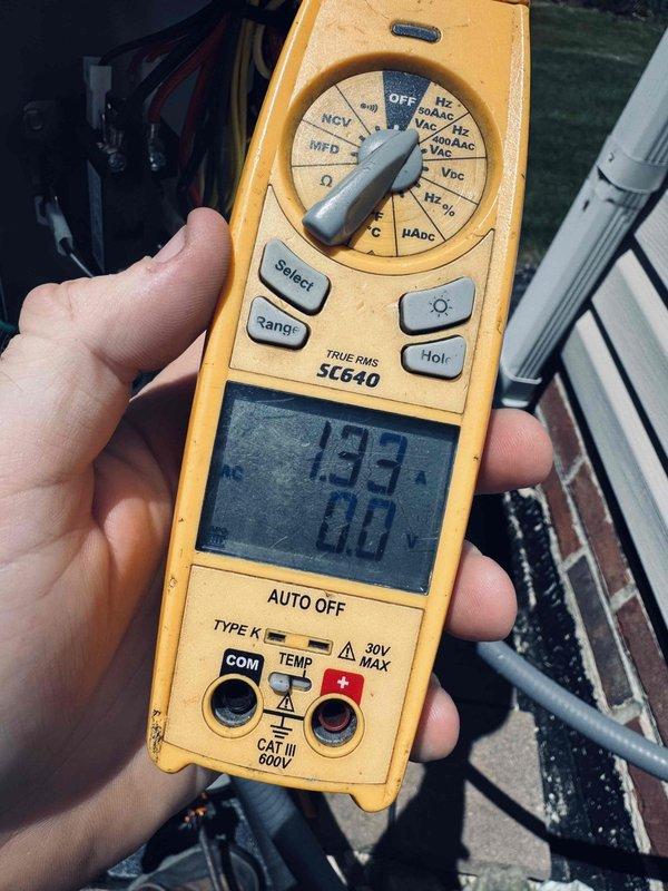 Performed routine maintenance on a one-year-old air conditioning system. Conducted electrical diagnostics using a digital multimeter to verify proper voltage and capacitance readings at the outdoor condensing unit. All measurements were within manufacturer specifications, indicating the system is operating efficiently with no electrical issues detected at this time.