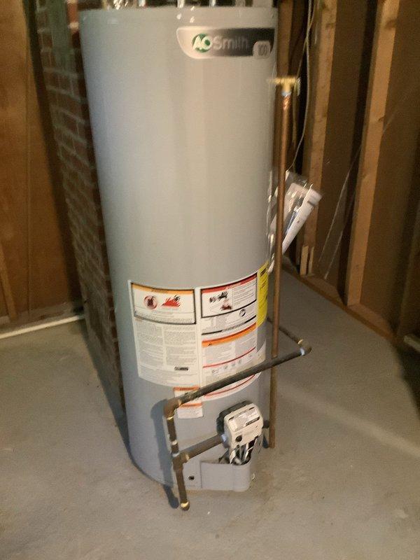 Performed complete flush and fill service on A.O. Smith natural gas tanked water heater of unknown age. Drained sediment buildup from tank, thoroughly flushed unit to remove mineral deposits and debris, refilled system, and verified proper operation of all components including gas valve assembly and plumbing connections.