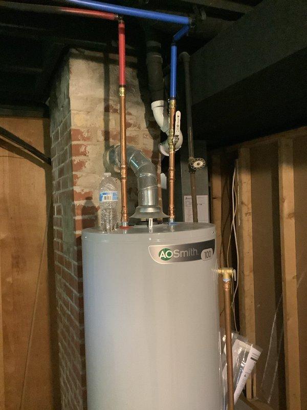 Performed complete flush and fill service on A.O. Smith natural gas tanked water heater of unknown age. Drained sediment buildup from tank, thoroughly flushed unit to remove mineral deposits and debris, refilled system, and verified proper operation of all components including gas valve assembly and plumbing connections.